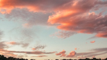 gray concrete road under cloudy sky during daytime