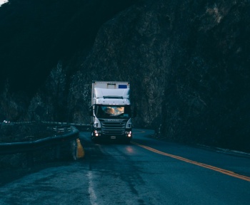 trailer truck passing on road near rail guard