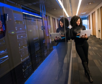 woman in black top using Surface laptop
