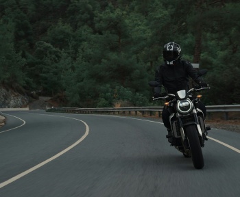 man riding motorcycle on concrete street