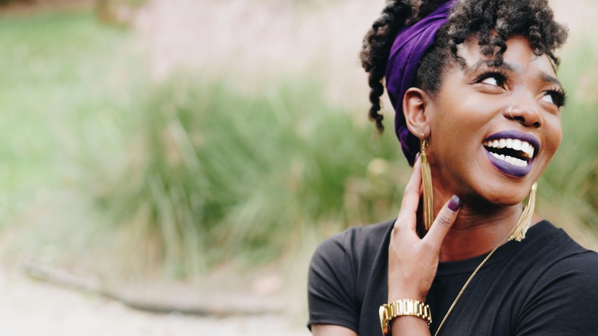 photo of woman wearing purple lipstick and black crew-neck shirt