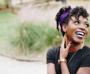 photo of woman wearing purple lipstick and black crew-neck shirt