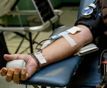 person on chair donating blood