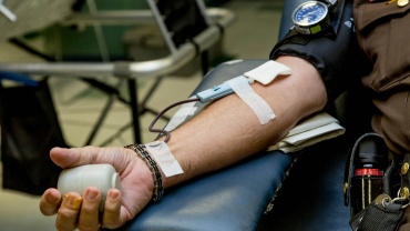 person on chair donating blood