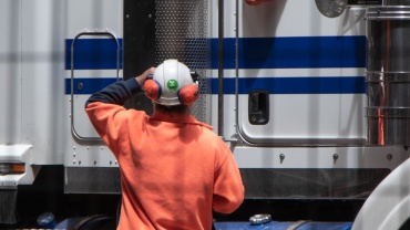 man standing in front of freight truck