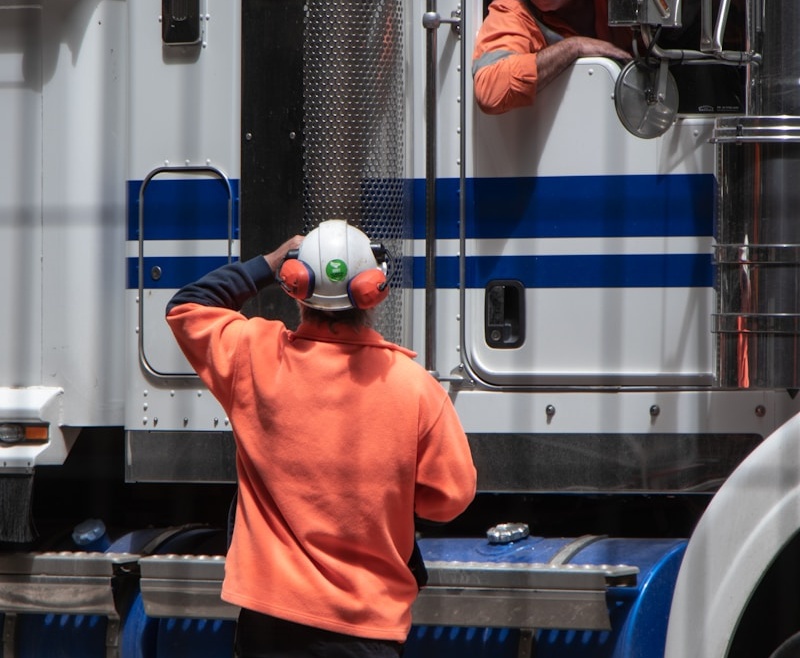man standing in front of freight truck